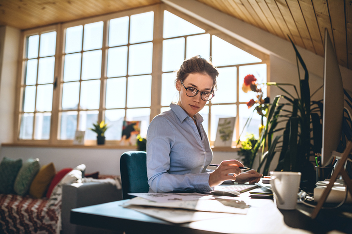 Hardworking Young Woman Drawing Sketches And Using PC Computer at Office